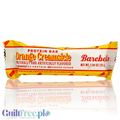 Baton proteinowy Barebells Orange Creamsicle w żółtym opakowaniu z Guiltfree, smak pomarańczowo-waniliowy.