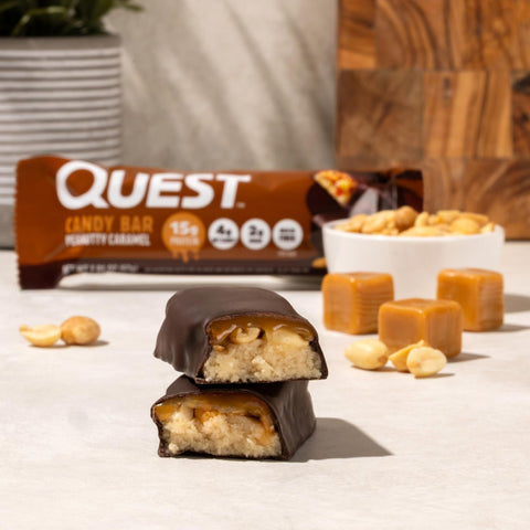 Guiltfree Quest Nutrition Peanutty Caramel protein bar with chocolate, gooey caramel, and peanuts, cross-section view.